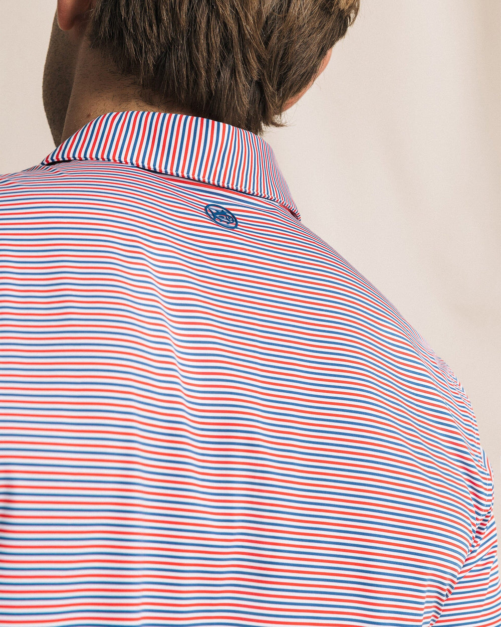 The detail view of the Southern Tide Pelican Landing Stripe Coastal Breeze® Performance Polo by Southern Tide - Channel Marker Red