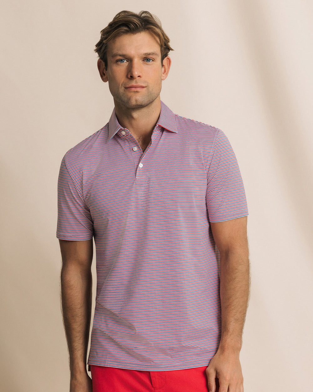 The front view of the Southern Tide Pelican Landing Stripe Coastal Breeze® Performance Polo by Southern Tide - Channel Marker Red