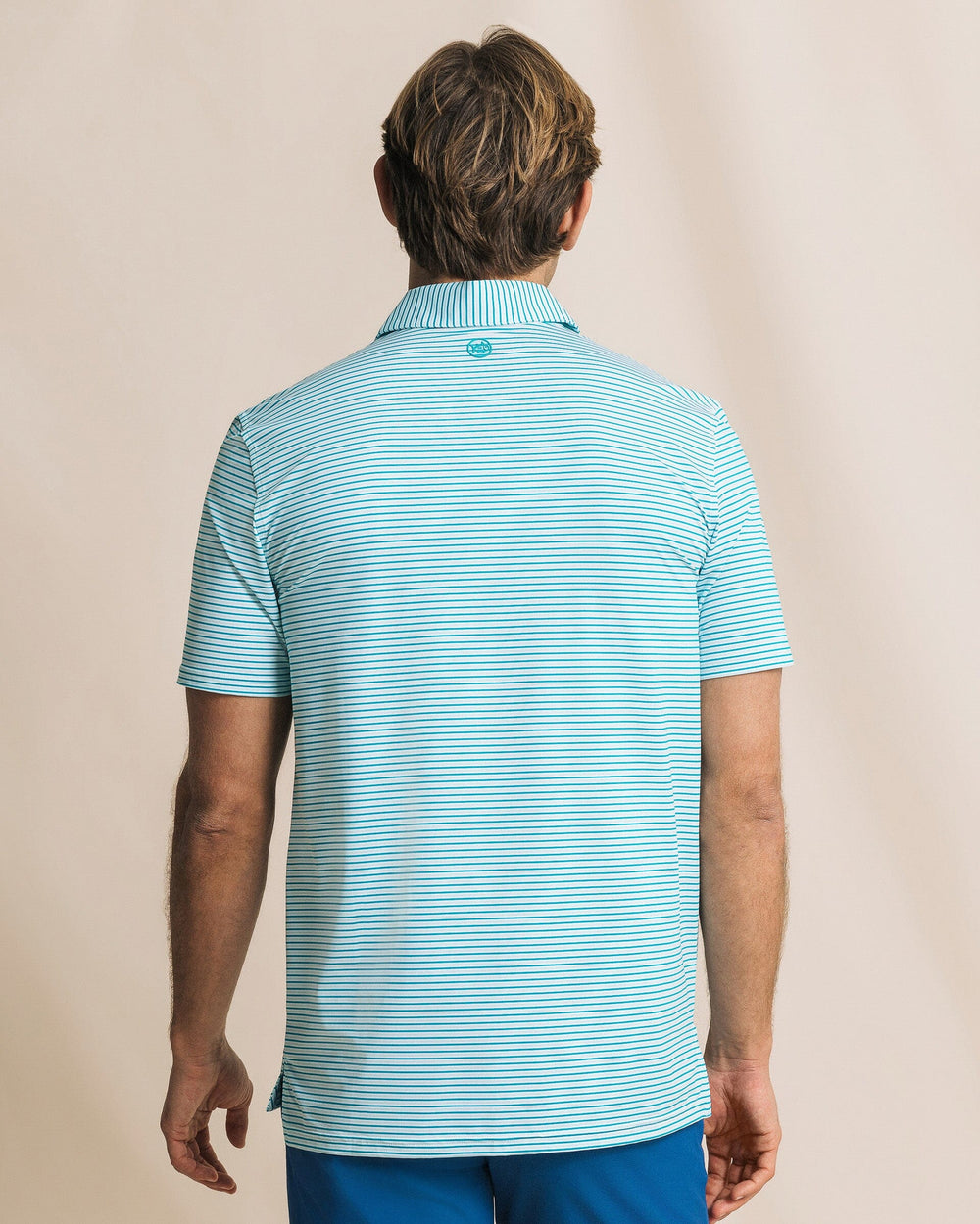 The back view of the Southern Tide Pelican Landing Stripe Coastal Breeze® Performance Polo by Southern Tide - Teal Depths