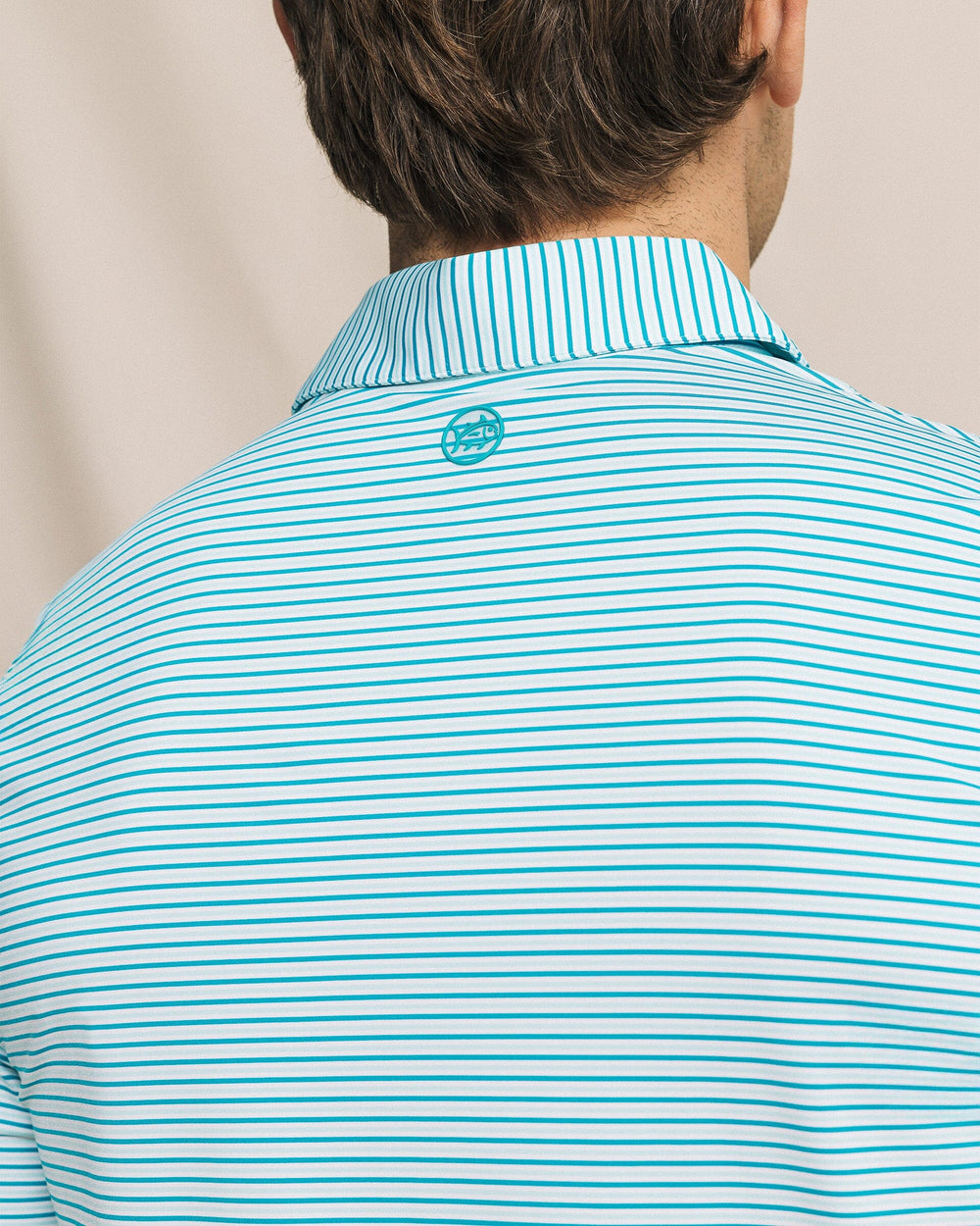 The detail view of the Southern Tide Pelican Landing Stripe Coastal Breeze® Performance Polo by Southern Tide - Teal Depths