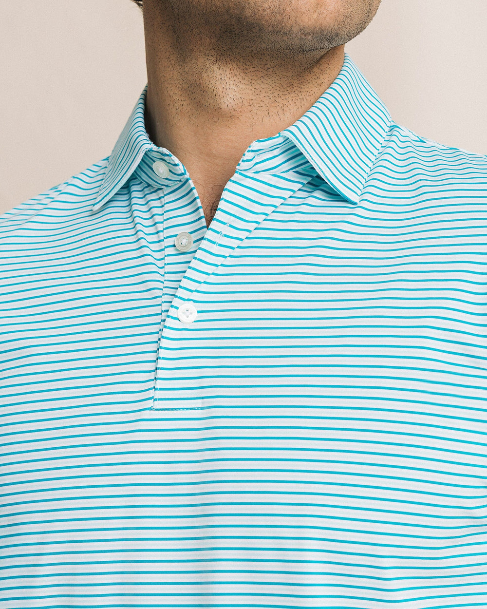 The detail view of the Southern Tide Pelican Landing Stripe Coastal Breeze® Performance Polo by Southern Tide - Teal Depths