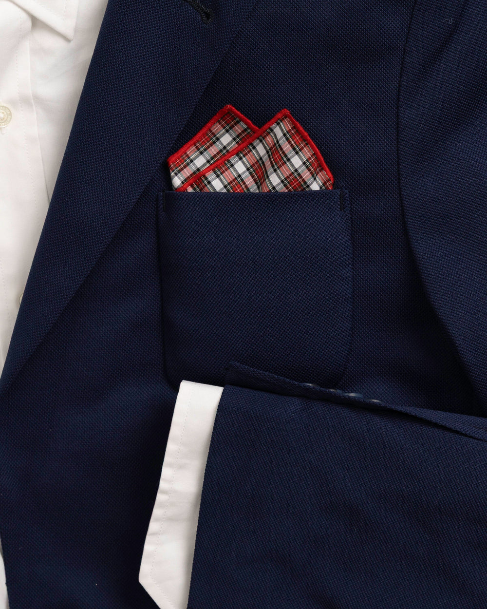 The detail coat view of the High Cotton Peppermint Plaid Cotton Pocket Square at Southern Tide - Red