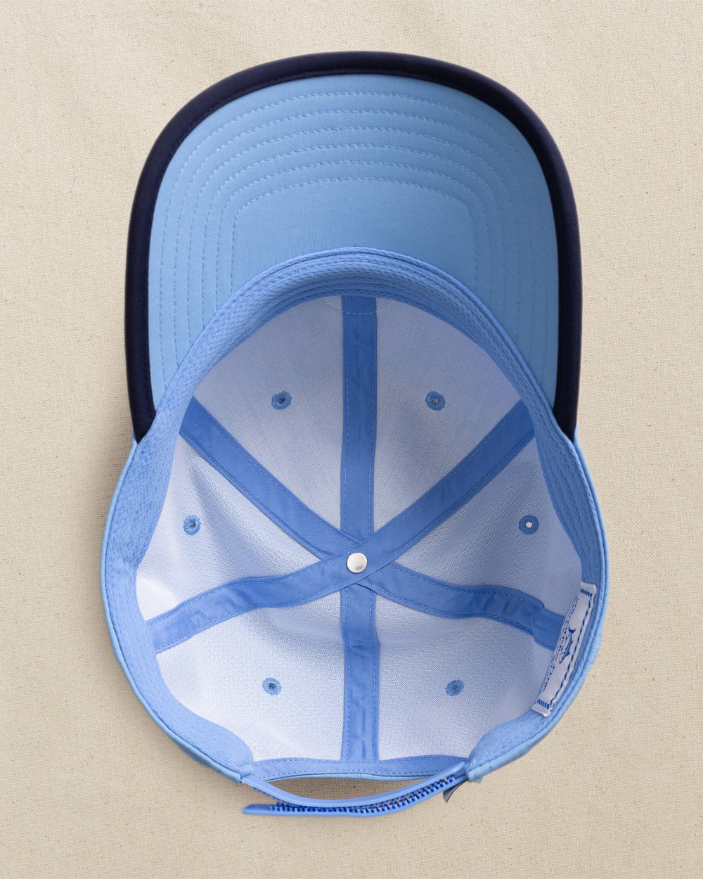 The detail view of the Southern Tide Rubber Skipjack Patch Performance Hat by Southern Tide - Blue