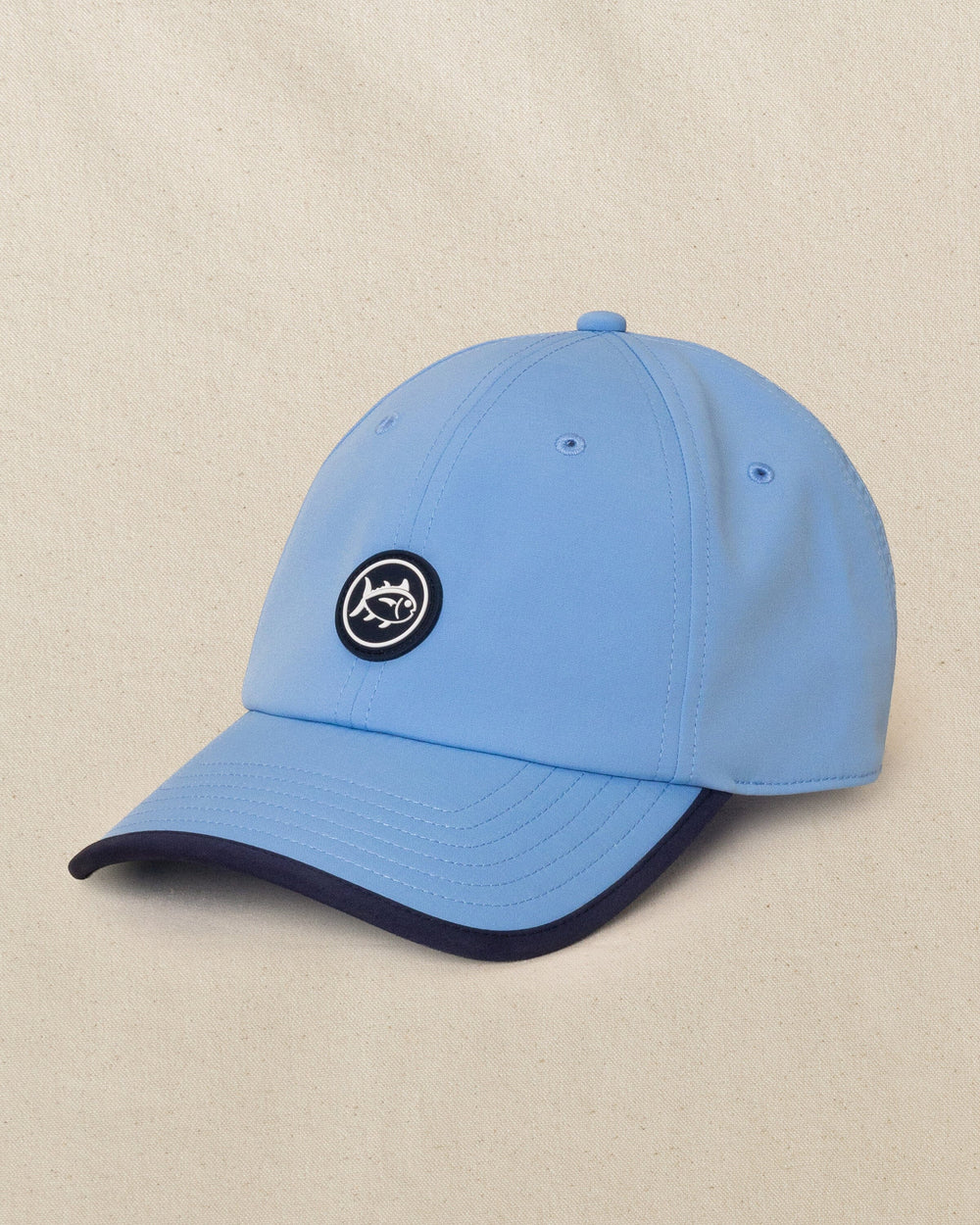 The side view of the Southern Tide Rubber Skipjack Patch Performance Hat by Southern Tide - Blue
