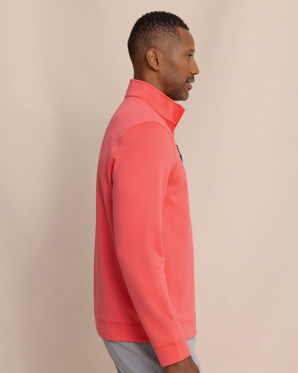The side view of the Southern Tide Schooner Quarter Zip by Southern Tide - Sunkist Coral
