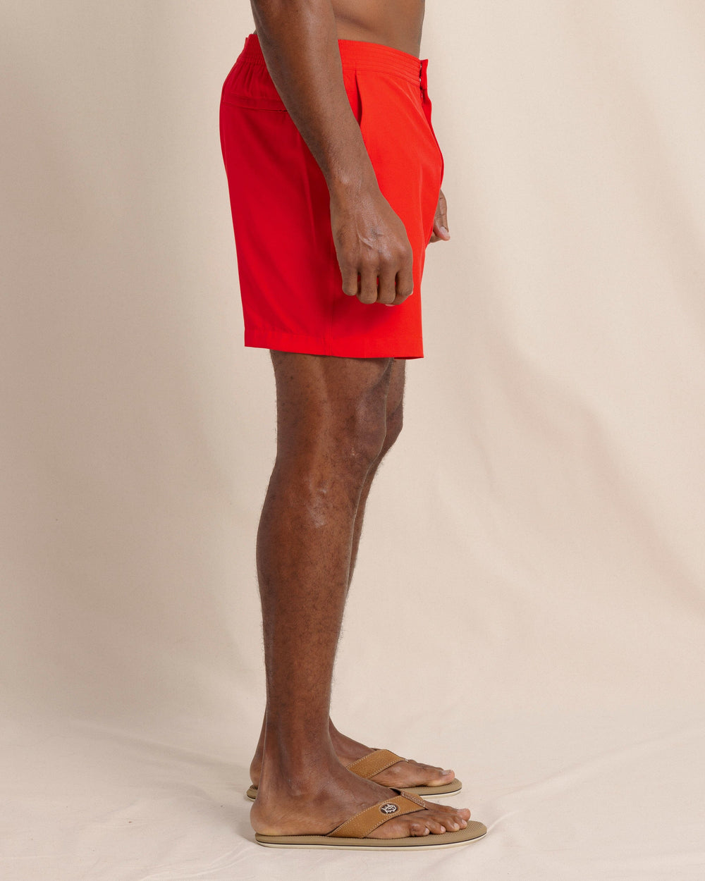 The side view of the Southern Tide Shelter Cove Swim Trunk by Southern Tide - Poppy Red