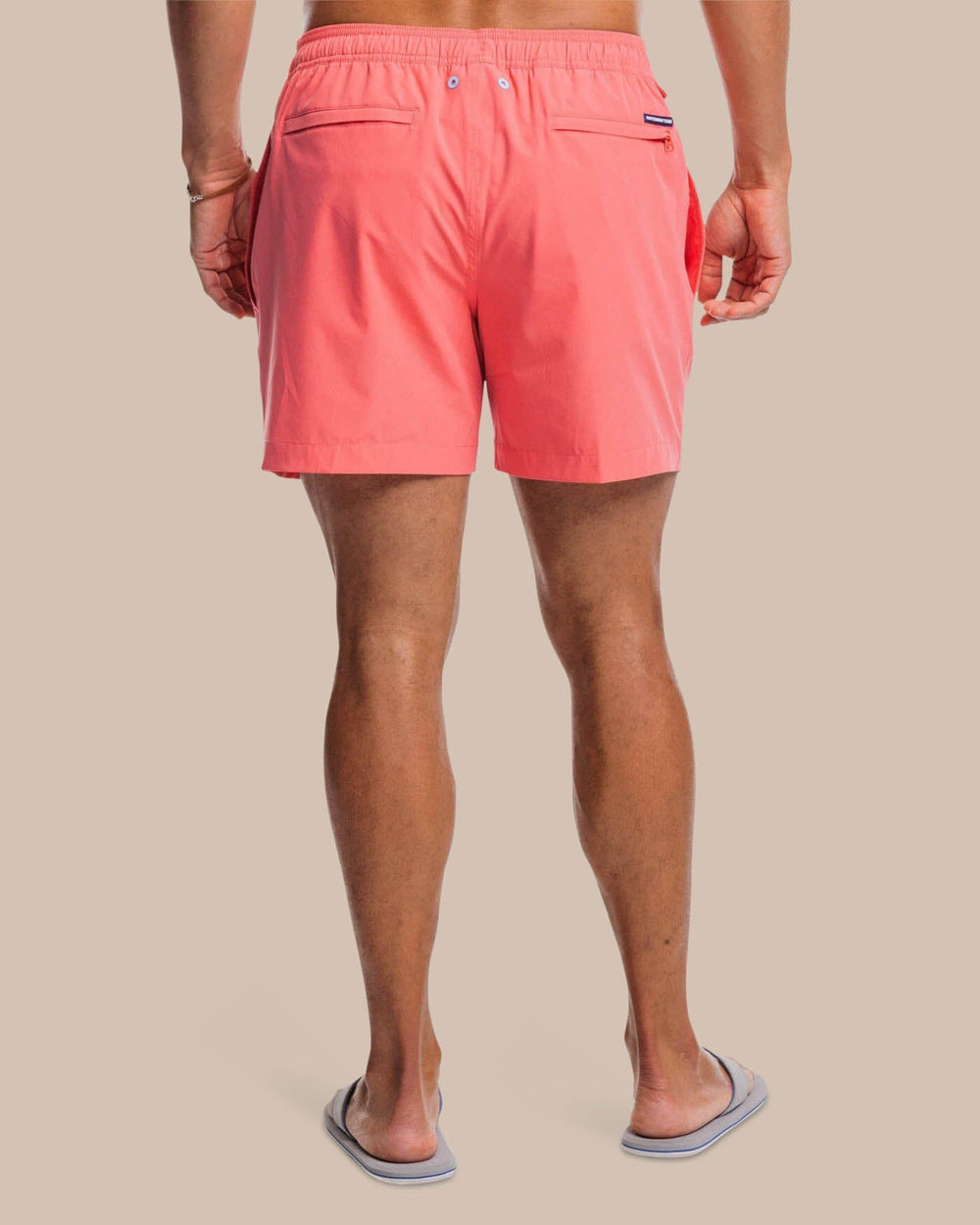 The back view of the Southern Tide Solid Swim Trunk 3 by Southern Tide - Sunkist Coral