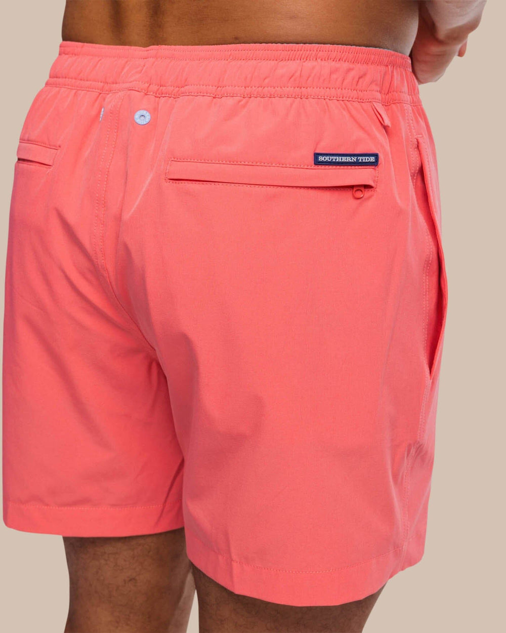 The detail view of the Southern Tide Solid Swim Trunk 3 by Southern Tide - Sunkist Coral