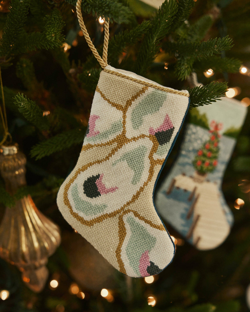 The lifestyle view of the Southern Tide Southern Oyster Needlepoint Stocking by Southern Tide - White