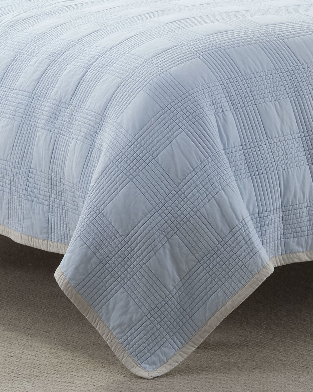 The front view of the Southern Tide Camden Quilt by Southern Tide - Ivory/Blue