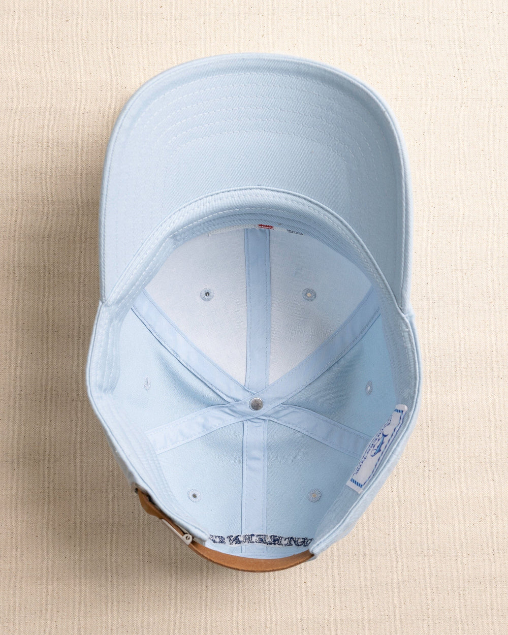 The under view of the Southern Tide ST Flag Leather Strap Hat by Southern Tide - Blue