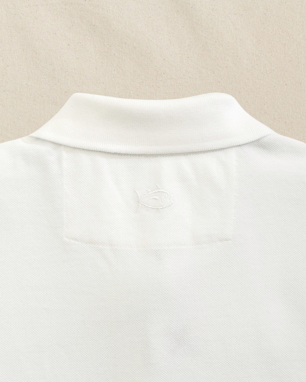 The detail view of the Southern Tide TCU Horned Frogs Skipjack Polo by Southern Tide - Classic White
