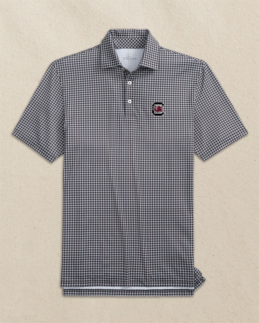 The front view of the Southern Tide USC Gamecocks Driver Dunes Edge Plaid Polo by Southern Tide - Black