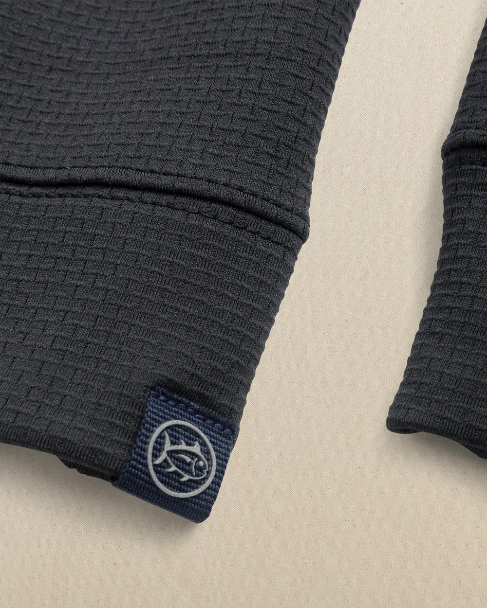 The detail view of the Southern Tide USC Gamecocks Schooner Quarter Zip Carolina Script by Southern Tide - Caviar Black