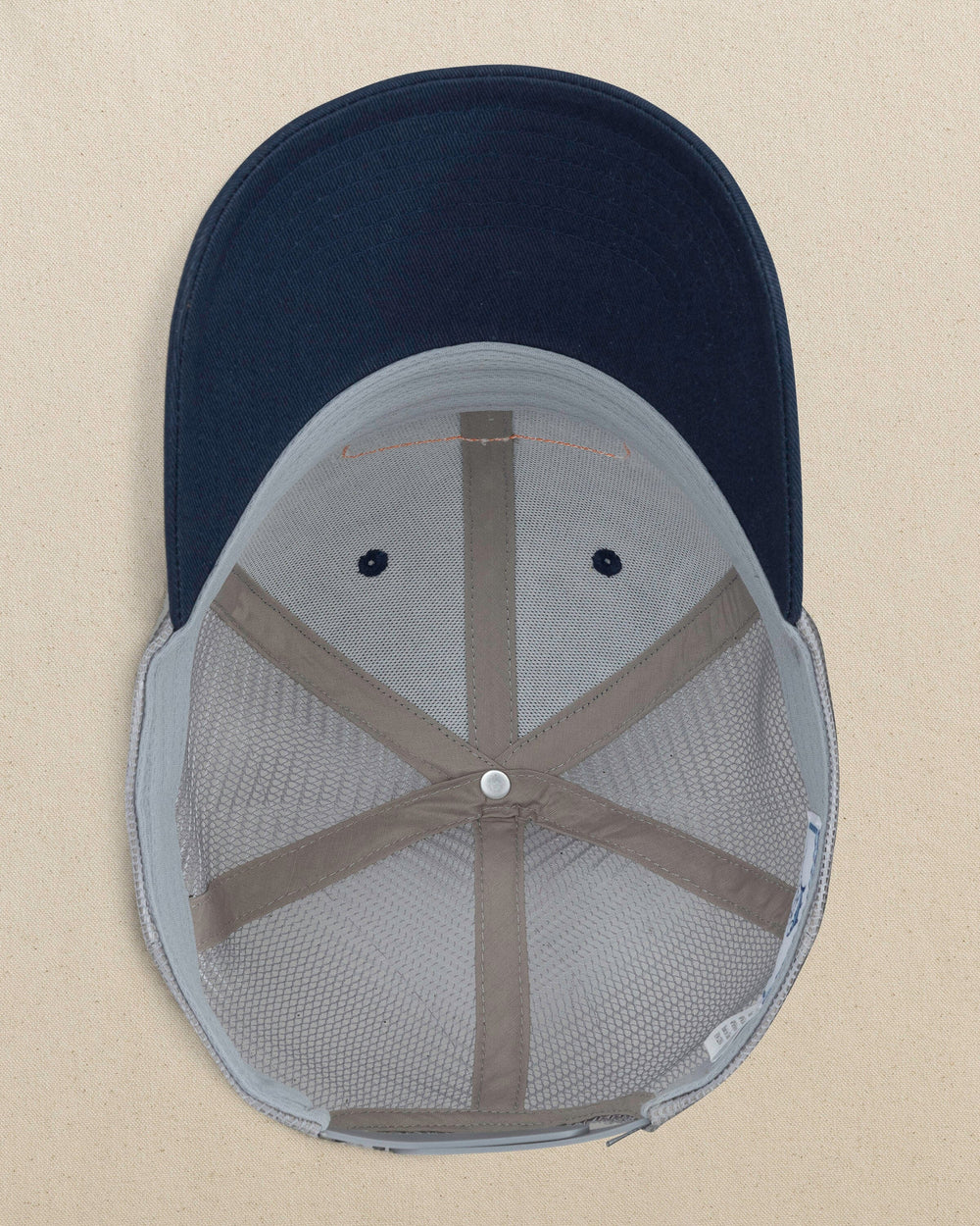 The under view of the Southern Tide Vintage Badge Trucker Hat by Southern Tide - Navy